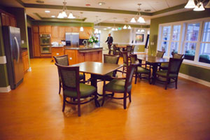 Walking through the open kitchen inside Heron Cove at Sanders, Virginia’s first deinstitutionalized nursing facility