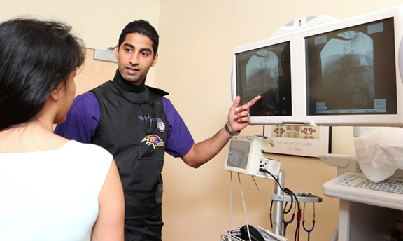 Dr. Sureja explains scans to a patient
