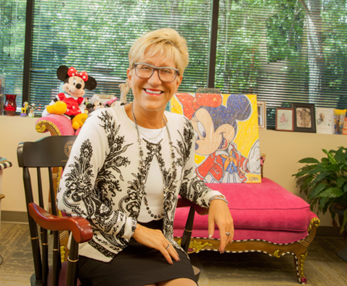 Dr. Robin Poe-Zeigler in her office, filled with Disney-themed gifts from patients.